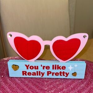 Quote from “Mean Girls” movie.  Wood Heart Sunglasses Decor